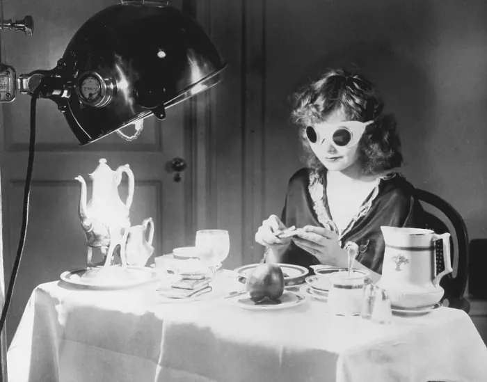 Framed Print : Woman Eating Meal Under an Ultraviolet Lamp