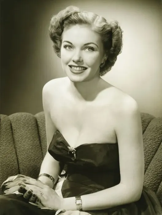 Framed Print : Woman in evening gown sitting on sofa, (B&W), (Portrait) Framed Print : Woman in evening gown sitting on sofa, (B&W), (Portrait)