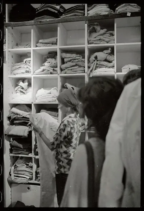 Framed Print : Woman Examining Pants in Store Framed Print : Woman Examining Pants in Store