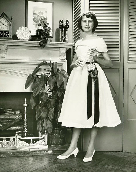 Woman in fashionable dress posing at fireplace, (B&W), (Portrait)