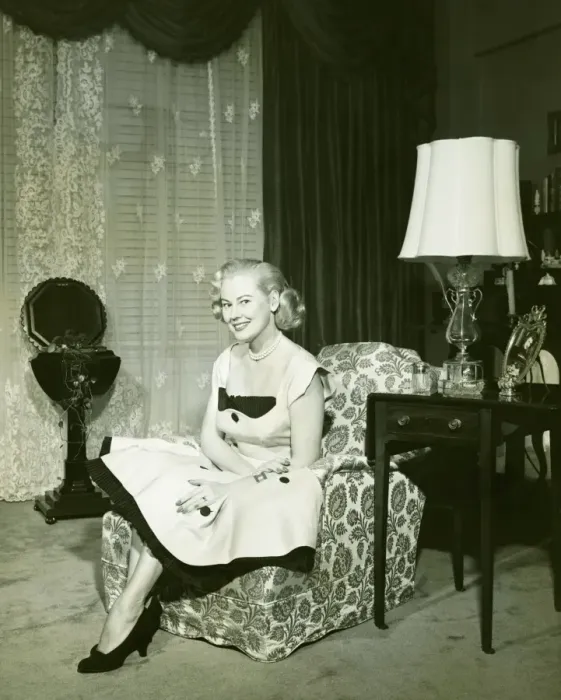 Framed Print : Woman in fashionable dress sitting on armchair in living room, (B&W), portrait Framed Print : Woman in fashionable dress sitting on armchair in living room, (B&W), portrait