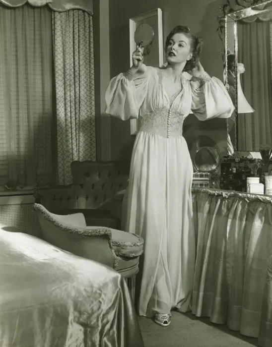 Framed Print : Woman in fashionable gown looking at mirror in bedroom, (B&W) Framed Print : Woman in fashionable gown looking at mirror in bedroom, (B&W)