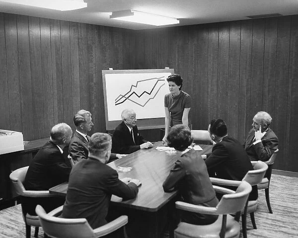 Woman giving presentation to group in meeting