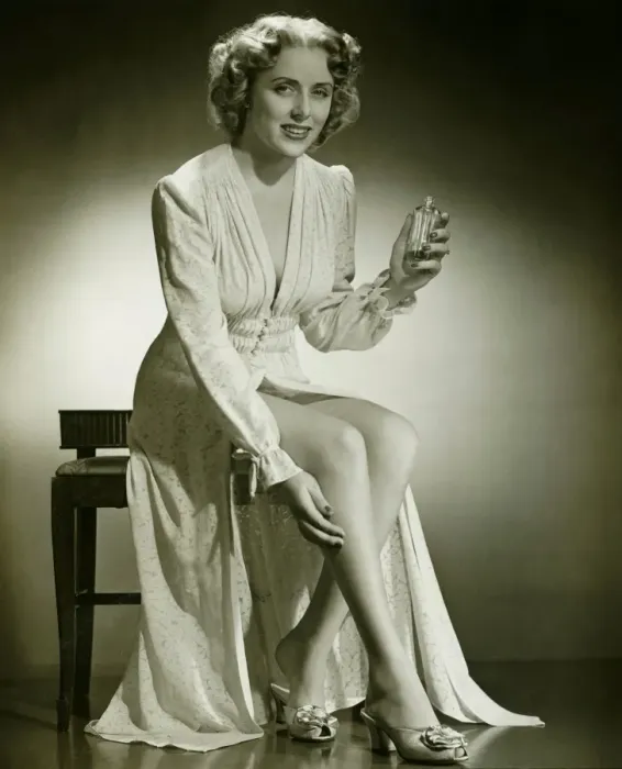Framed Print : Woman in gown sitting on stool, holding perfume, (B&W), portrait Framed Print : Woman in gown sitting on stool, holding perfume, (B&W), portrait
