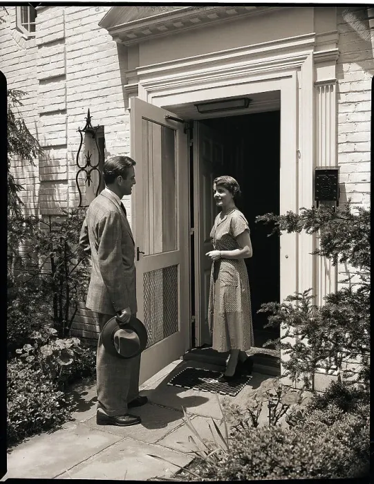 Framed Print : Woman Greeting Man at Door Framed Print : Woman Greeting Man at Door