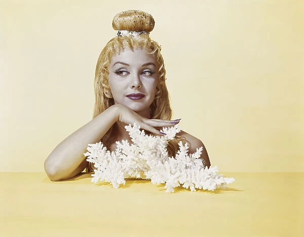 Woman with hairstyle and make-up against yellow background