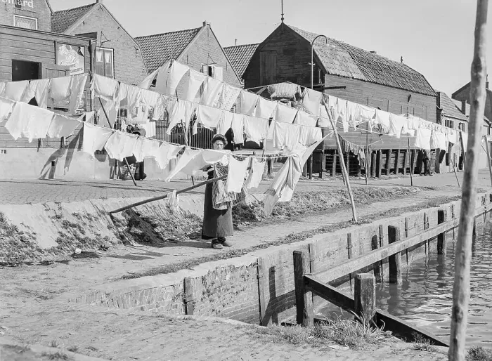 Framed Print : Woman Hanging Clothes to Dry on Docks Framed Print : Woman Hanging Clothes to Dry on Docks