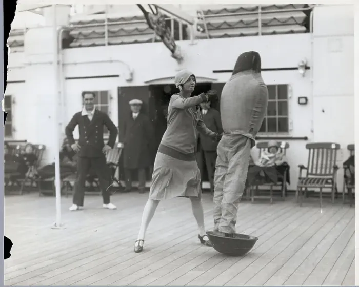 Framed Print : Woman Hits Dummy Figure on Ship Deck Framed Print : Woman Hits Dummy Figure on Ship Deck