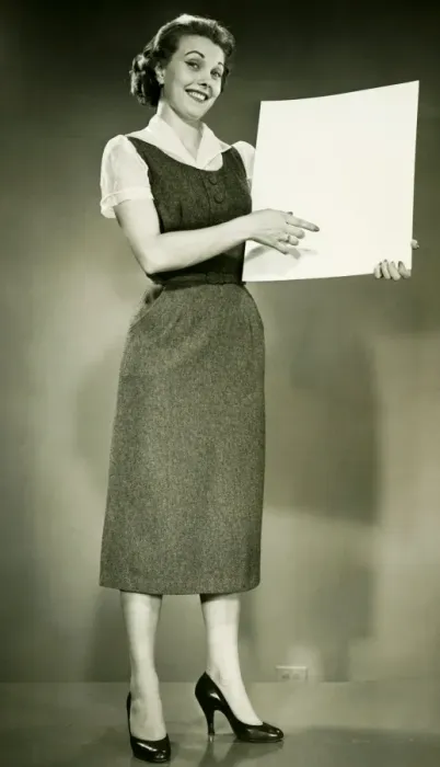 Framed Print : Woman holding blank sheet of paper, posing in studio, (B&W), portrait Framed Print : Woman holding blank sheet of paper, posing in studio, (B&W), portrait