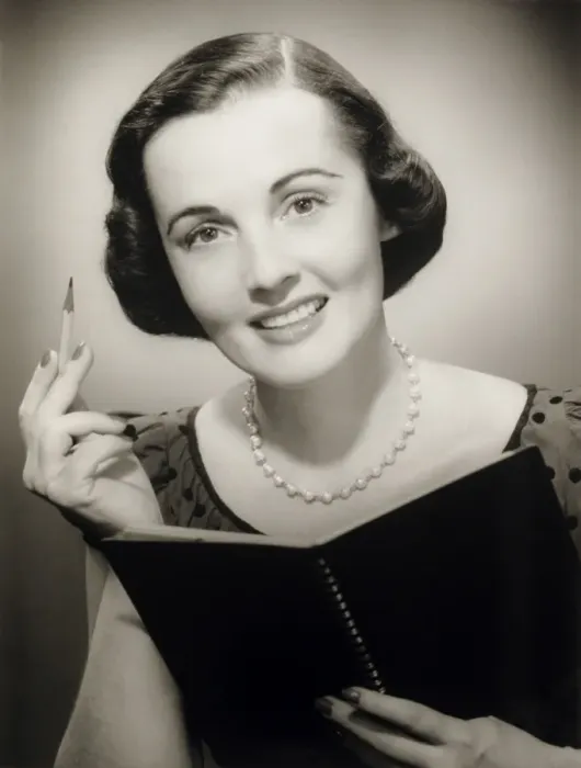 Framed Print : Woman holding pencil and notebook, posing in studio, (B&W), (Close-up), (Portrait) Framed Print : Woman holding pencil and notebook, posing in studio, (B&W), (Close-up), (Portrait)