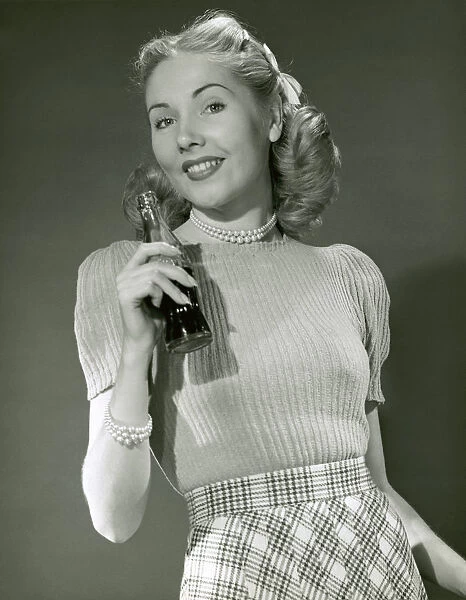Woman holding soda bottle