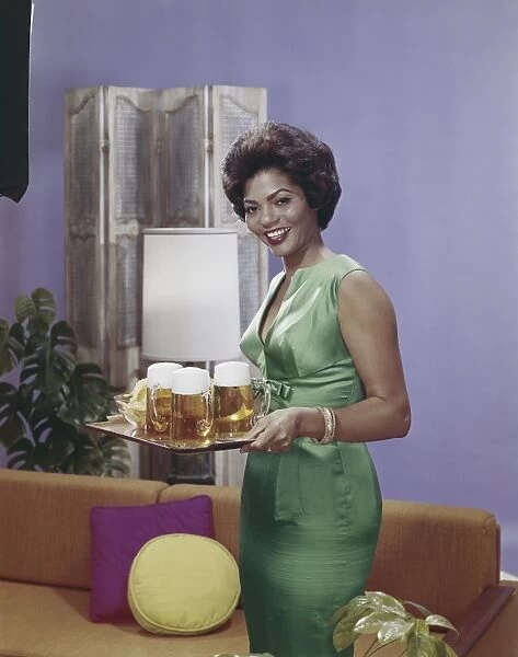 Woman holding tray with beer glasses, smiling, portrait