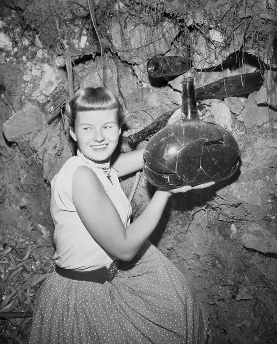 Framed Print : Woman Holding Unearthed Bottle Framed Print : Woman Holding Unearthed Bottle
