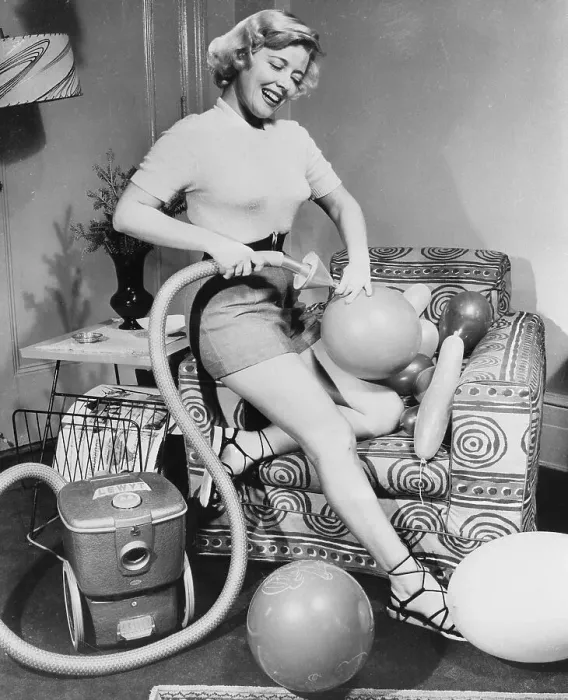 Framed Print : Woman Inflating Balloons with a Vacuum Cleaner Framed Print : Woman Inflating Balloons with a Vacuum Cleaner