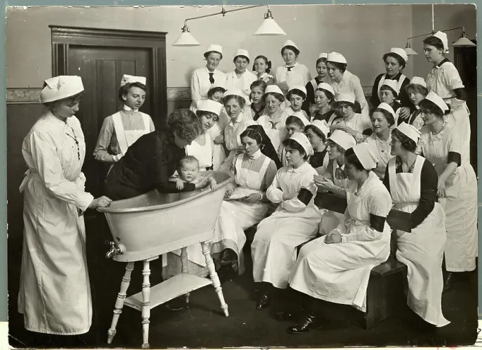 Framed Print : Woman Instructing How to Bathe Babies Framed Print : Woman Instructing How to Bathe Babies
