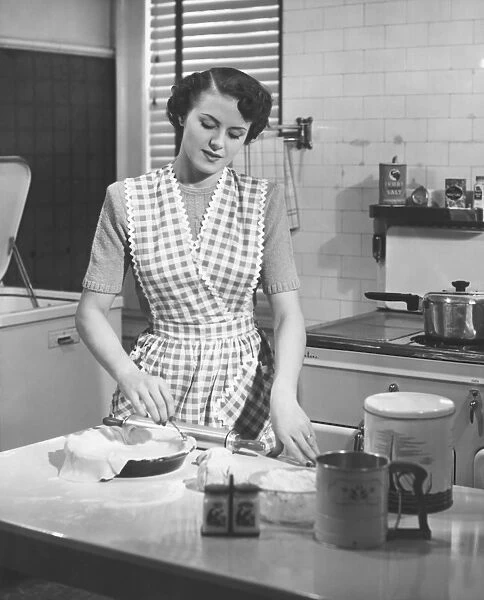 Woman in kitchen making pie (B&W)