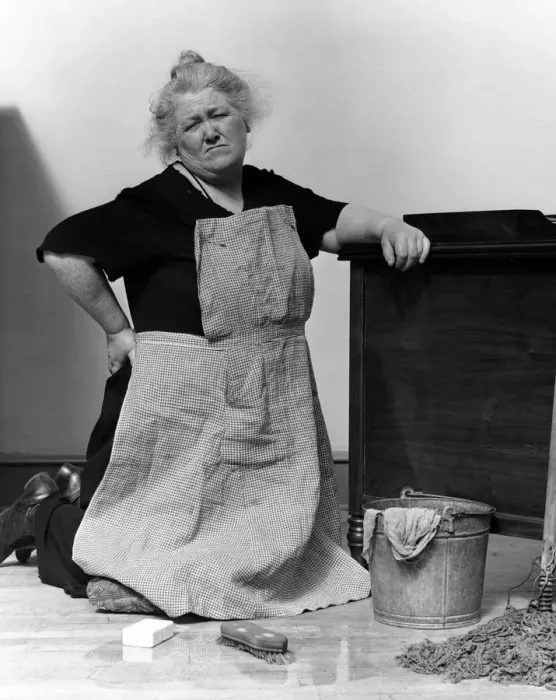 Framed Print : Woman on knees with mop and bucket, scowling Framed Print : Woman on knees with mop and bucket, scowling