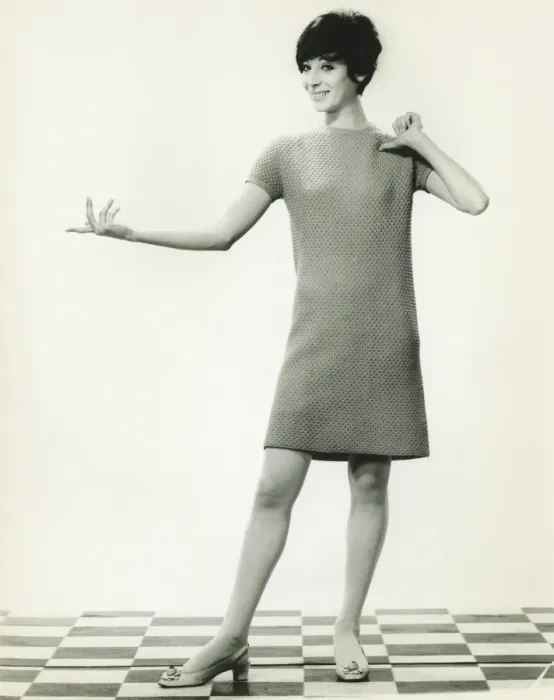 Framed Print : Woman in knitted dress gesturing in studio, (B&W), portrait Framed Print : Woman in knitted dress gesturing in studio, (B&W), portrait