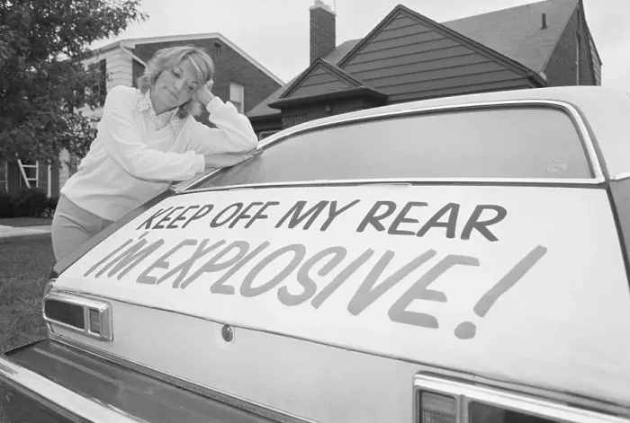 Framed Print : Woman Leaning on Ford Pinto with Warning Sign