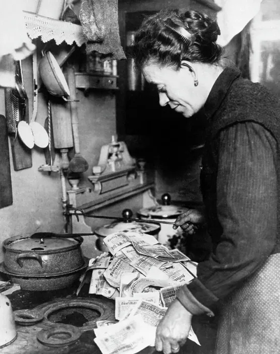 Framed Print : Woman Lighting Fire with German Money Framed Print : Woman Lighting Fire with German Money