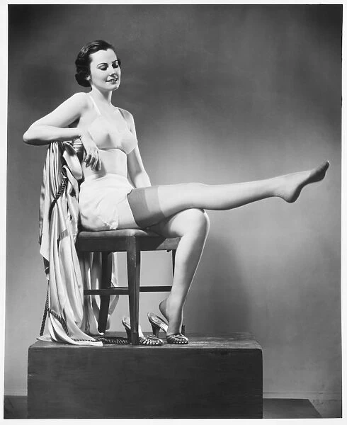 Woman in lingerie posing in studio, (B&W)