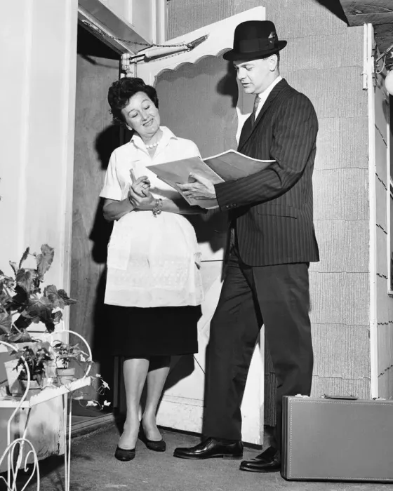 Framed Print : Woman listening to salesman in doorway Framed Print : Woman listening to salesman in doorway