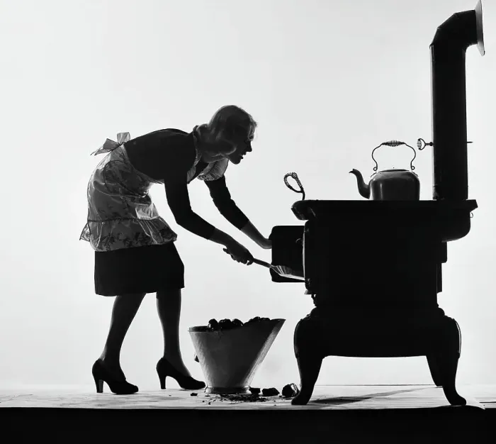 Framed Print : Woman Loading Stove With Coal Framed Print : Woman Loading Stove With Coal