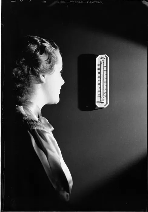Framed Print : Woman Looking at Thermometer Framed Print : Woman Looking at Thermometer