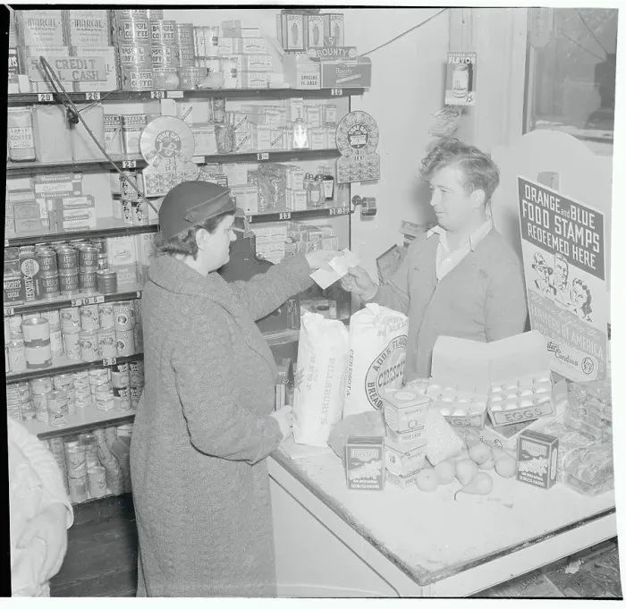 Framed Print : Woman Making a Purchase with Food Stamps Framed Print : Woman Making a Purchase with Food Stamps