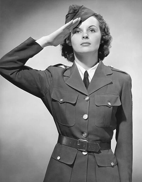 Woman in military uniform saluting