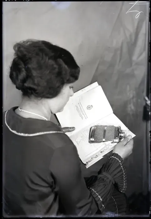 Framed Print : Woman Opening Book Containing Flask Framed Print : Woman Opening Book Containing Flask