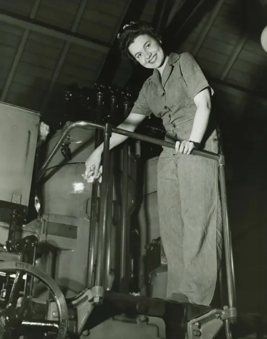 Framed Print : Woman operating machine in factory, (B&W), portrait, low angle view Framed Print : Woman operating machine in factory, (B&W), portrait, low angle view