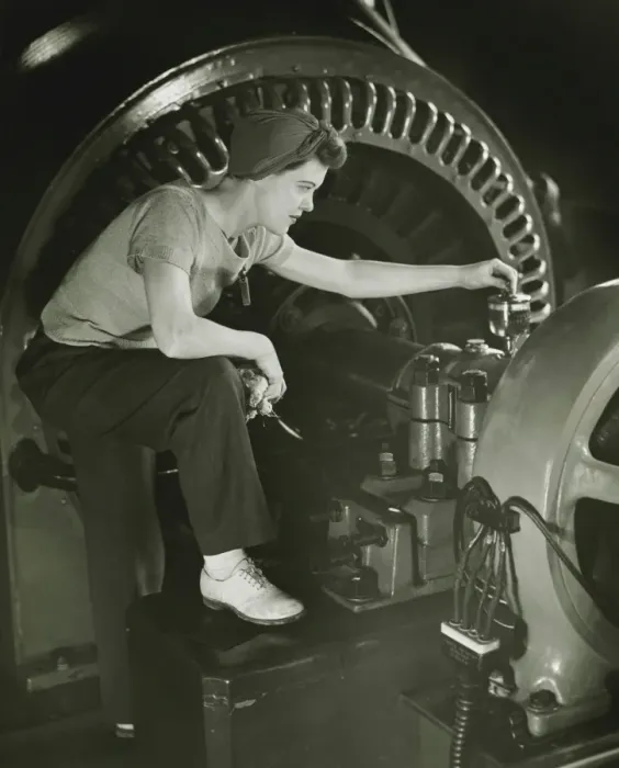 Framed Print : Woman operating machine in factory, (B&W) Framed Print : Woman operating machine in factory, (B&W)