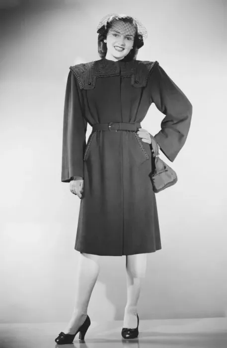 Framed Print : Woman in overcoat posing in studio (B&W), portrait Framed Print : Woman in overcoat posing in studio (B&W), portrait