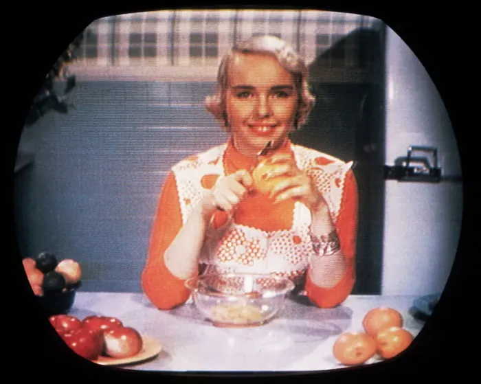 Framed Print : Woman Peeling Oranges on TV Framed Print : Woman Peeling Oranges on TV