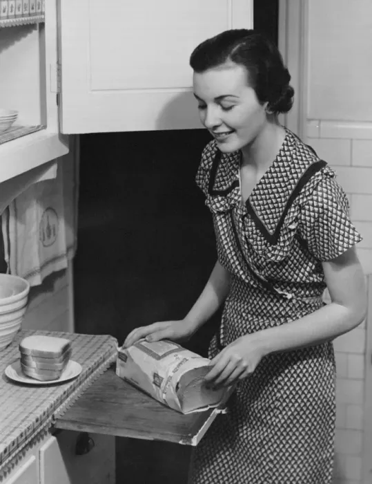 Framed Print : Woman placing bread on plate Framed Print : Woman placing bread on plate