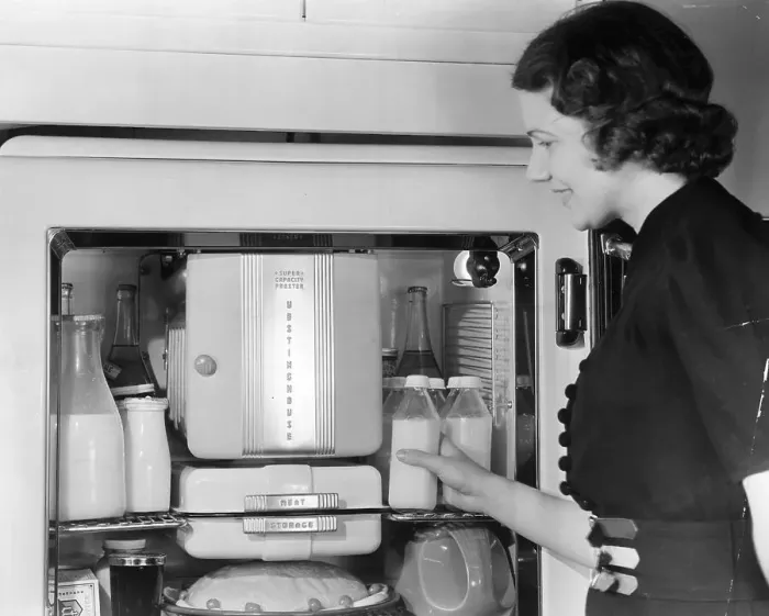 Framed Print : Woman Placing Milk In Old Refrigerator Framed Print : Woman Placing Milk In Old Refrigerator