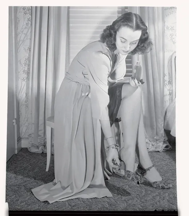 Framed Print : Woman Placing Perfumed Pad Inside Shoe Framed Print : Woman Placing Perfumed Pad Inside Shoe