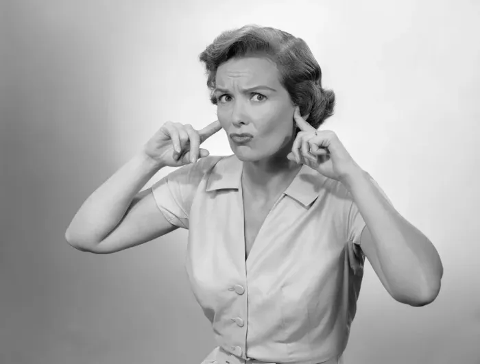 Framed Print : Woman plugging ears Framed Print : Woman plugging ears