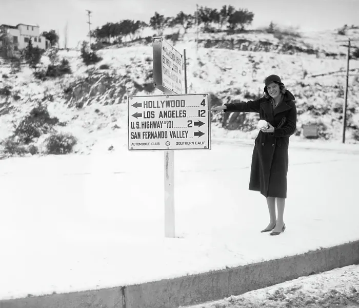 Framed Print : Woman Pointing to Sign in Snowy California Framed Print : Woman Pointing to Sign in Snowy California