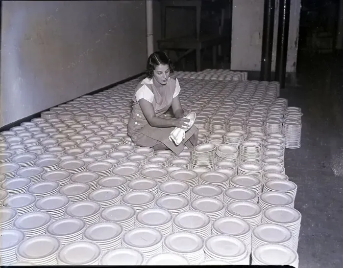 Framed Print : Woman Polishing Piles of Plates Framed Print : Woman Polishing Piles of Plates