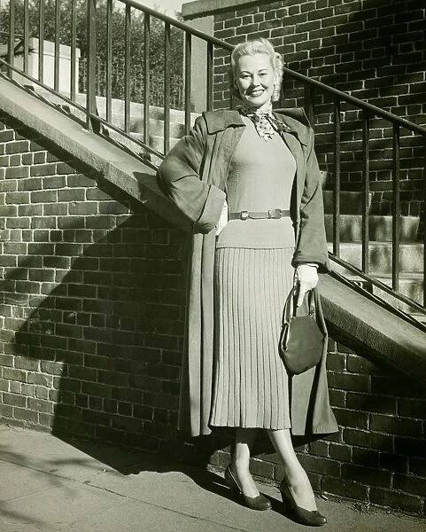 Woman posing by steps, (B&W), (Portrait)