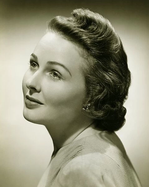 Woman posing in studio, (B&W), close-up, portrait