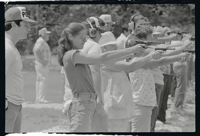 Framed Print : Woman Practicing Firing a Gun Framed Print : Woman Practicing Firing a Gun