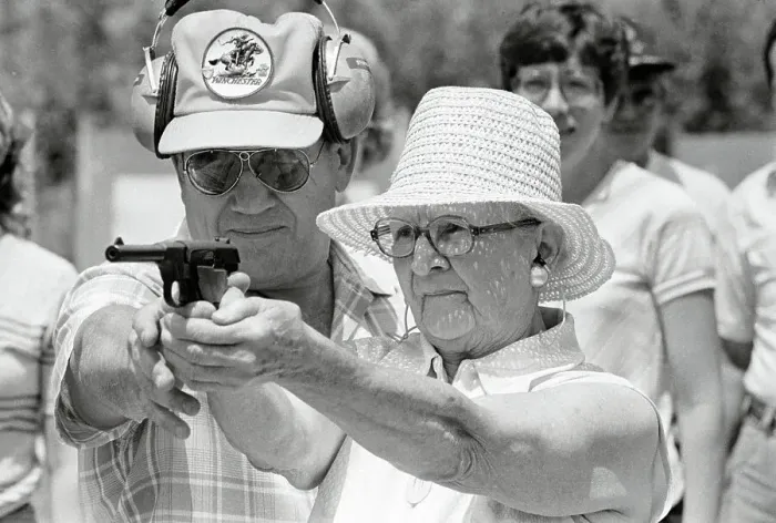 Framed Print : Woman Practicing Firing a Gun Framed Print : Woman Practicing Firing a Gun