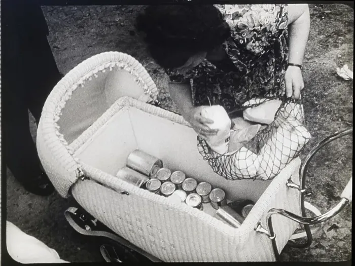 Framed Print : Woman Puts Netted Basket Into Baby Carri Framed Print : Woman Puts Netted Basket Into Baby Carri