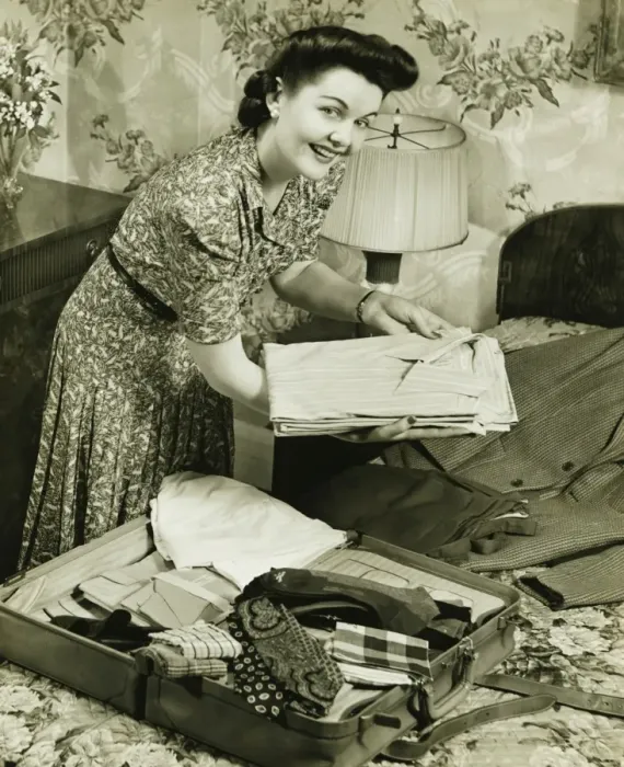 Framed Print : Woman putting clothes into suitcase, (B&W) Framed Print : Woman putting clothes into suitcase, (B&W)