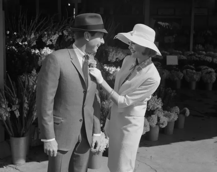 Framed Print : Woman putting flower on mans suit Framed Print : Woman putting flower on mans suit