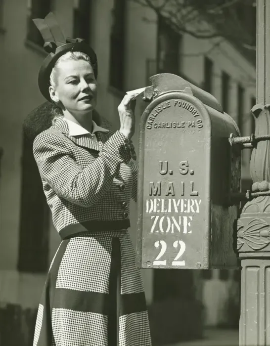 Framed Print : Woman putting letter into mailbox, (B&W) Framed Print : Woman putting letter into mailbox, (B&W)