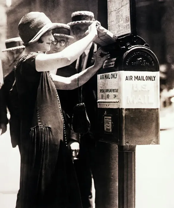 Framed Print : Woman Putting Package into First Airmail Framed Print : Woman Putting Package into First Airmail